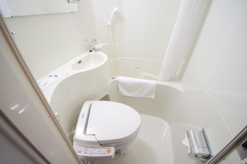 a small bathroom with a toilet and a sink at Super Hotel Gotenba - 1 in Gotemba