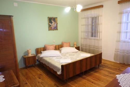 a bedroom with a bed in a room at House Dragica in Grižane