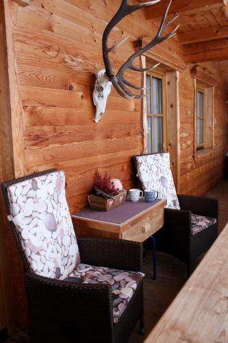 a dining room with a table and two chairs at Ferienhaus Waidmannsruh in Hippach