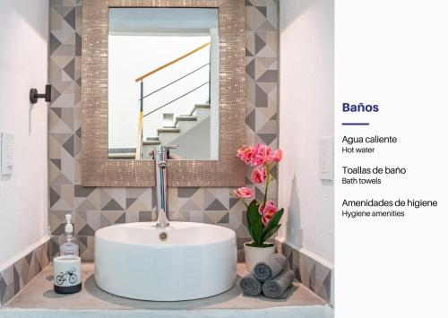 a bathroom with a sink and a mirror at Vida Casa Kuxtal Rooftop con vista al Lago in Vista Hermosa