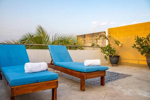 a pair of blue chairs sitting on a patio at Vida Casa Kuxtal Rooftop con vista al Lago in Vista Hermosa