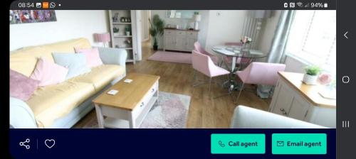 a living room with a couch and a table at Hartgrove in Gurnard