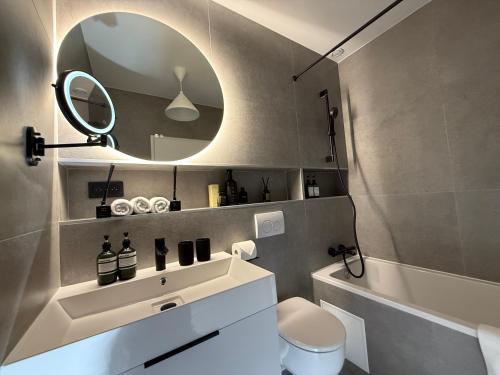 ein Badezimmer mit Waschbecken, Spiegel und Toilette in der Unterkunft Lifestyle Disneyland Paris 8 PAX in Serris