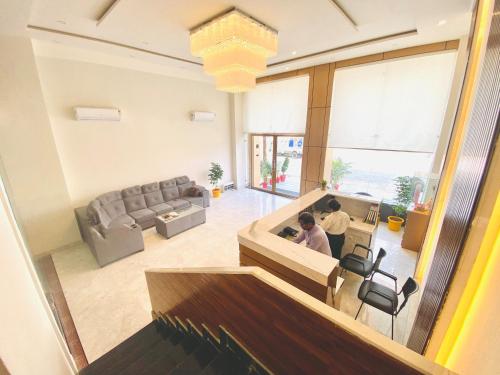 an overhead view of a living room with two people sitting at a table at Ayansh Klyde Inn, Lucknow in Lucknow