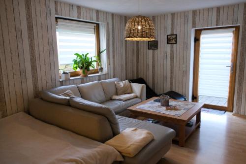 a living room with a couch and a table at "Gemütliches HomeAway" - Dein Zuhause in der Ferne in Kirchberg an der Jagst