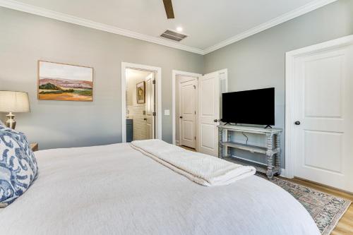 a bedroom with a bed and a flat screen tv at Historic Location Townhome in Johns Island! in Johns Island