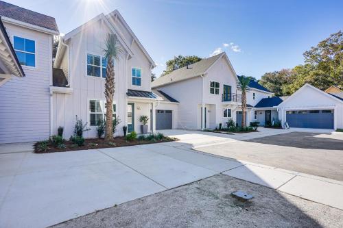 a white house with a palm tree in a driveway at Historic Location Townhome in Johns Island! in Johns Island