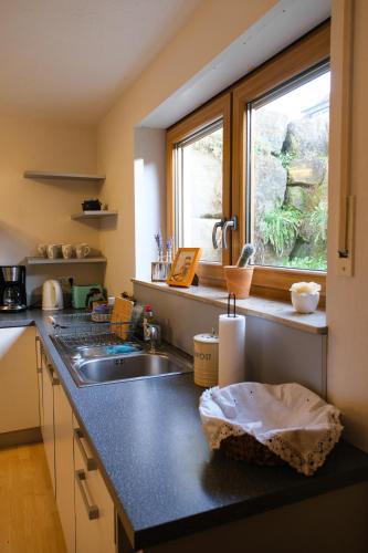 a kitchen with a sink and a window at "Gemütliches HomeAway" - Dein Zuhause in der Ferne in Kirchberg an der Jagst