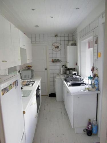 a white kitchen with white cabinets and appliances at Cheerful 2 bedroom town house in Lancashire in Chorley