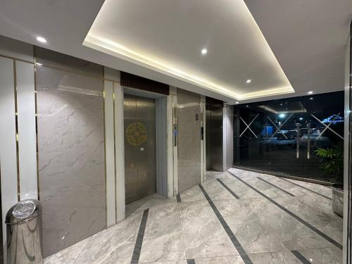 a lobby of a building with a glass wall at *Designer’s Luxurious 1BHK at Top Location of Twin Cities!! in Rawalpindi