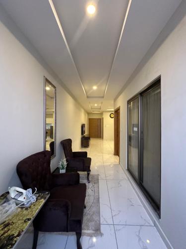 a living room with two couches and a table at *Designer’s Luxurious 1BHK at Top Location of Twin Cities!! in Rawalpindi