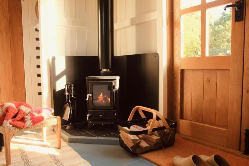a living room with a fireplace and a door at Peatlands in Ballybogy
