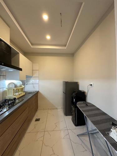 a kitchen with a counter and a refrigerator at *Designer’s Luxurious 1BHK at Top Location of Twin Cities!! in Rawalpindi