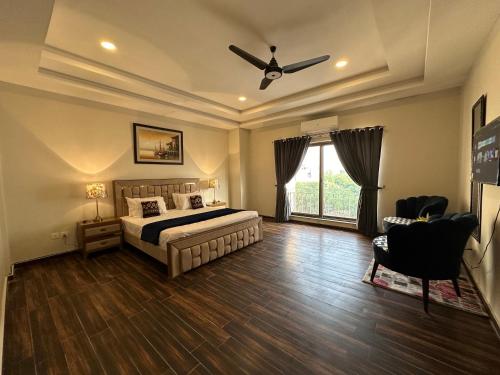 a bedroom with a bed and a ceiling fan at *Designer’s Luxurious 1BHK at Top Location of Twin Cities!! in Rawalpindi