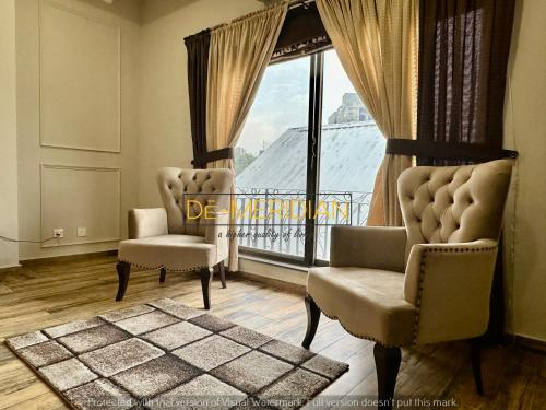 a living room with two chairs and a large window at *Designer’s Luxurious 1BHK at Top Location of Twin Cities!! in Rawalpindi