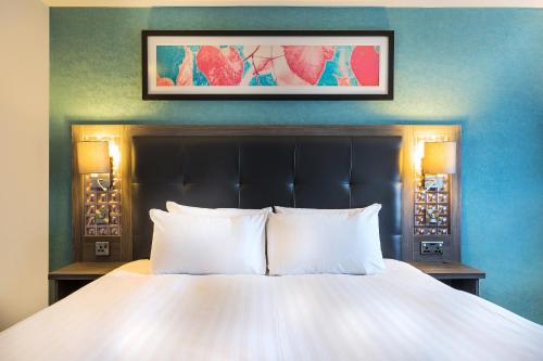 a bed with two white pillows in a room at Leonardo Hotel Plymouth in Plymouth