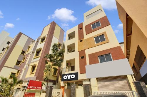 a sign in front of some buildings at Hotel O Lavish Stay in Hyderabad