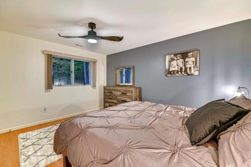 a bedroom with a bed and a ceiling fan at 2 Mi to Six Flags Lake George Home with Large Patio in Queensbury