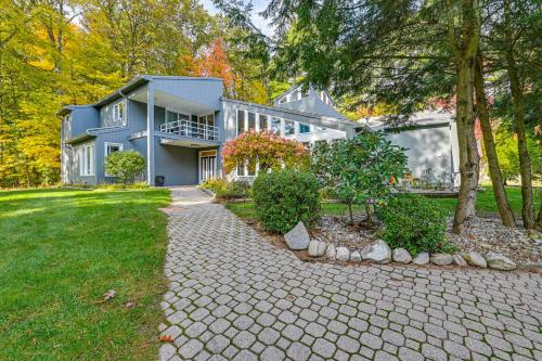 a large blue house with a stone driveway at 2 Mi to Six Flags Lake George Home with Large Patio in Queensbury
