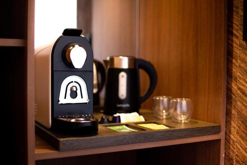 a coffee maker on a shelf in a hotel room at Hotel de Sal Luna Salada in Colchani