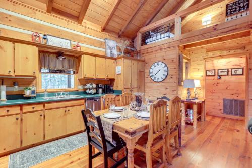 a kitchen with a table and chairs and a clock at Hot Tub and Games Ridgetop Cabin in Blue Ridge! in Blue Ridge