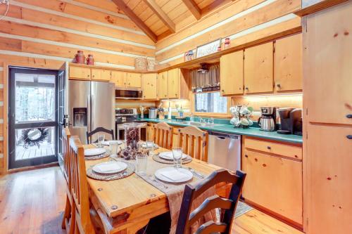a large kitchen with a wooden table and chairs at Hot Tub and Games Ridgetop Cabin in Blue Ridge! in Blue Ridge