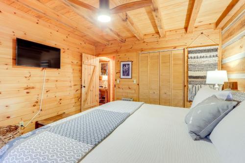 a bedroom with a bed and a flat screen tv at Hot Tub and Games Ridgetop Cabin in Blue Ridge! in Blue Ridge