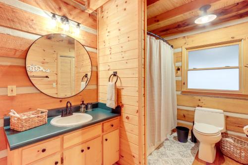 a bathroom with a sink and a mirror at Hot Tub and Games Ridgetop Cabin in Blue Ridge! in Blue Ridge