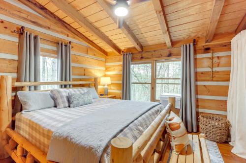 a bedroom with a bed in a log cabin at Hot Tub and Games Ridgetop Cabin in Blue Ridge! in Blue Ridge