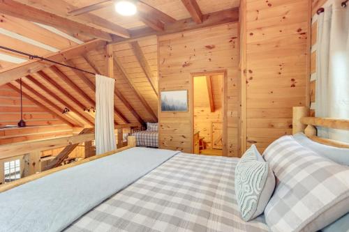 a bedroom in a log cabin with a bed at Hot Tub and Games Ridgetop Cabin in Blue Ridge! in Blue Ridge