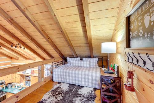 a bedroom with a bed in a wooden cabin at Hot Tub and Games Ridgetop Cabin in Blue Ridge! in Blue Ridge