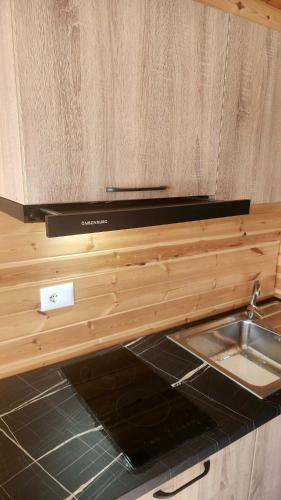 a kitchen with a sink and a counter top at UniKlajd Villa-s in Golem
