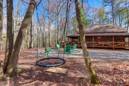 a playground in front of a log cabin at Hot Tub and Games Ridgetop Cabin in Blue Ridge! in Blue Ridge