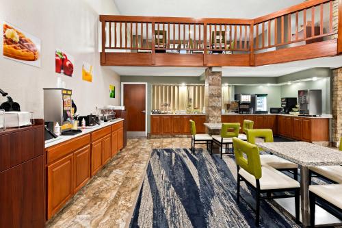 a lobby of a fast food restaurant with a table and chairs at Suburban Studios Mason Near Kings Island in Mason
