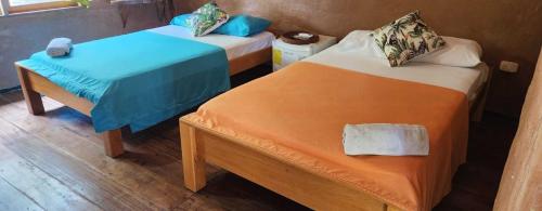 Postel nebo postele na pokoji v ubytování Hotel Cabaña Guainiana