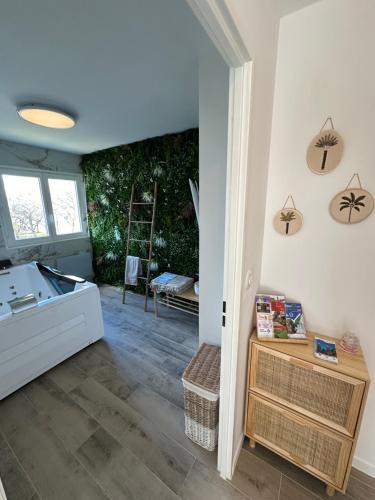 a living room with a hallway with a table and a room with at MarbleMood Spa in Obernai