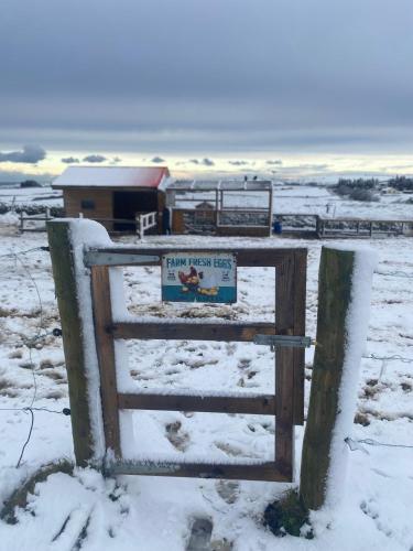 a sign on a gate in the snow at Riverfield Apartment in Miltown Malbay