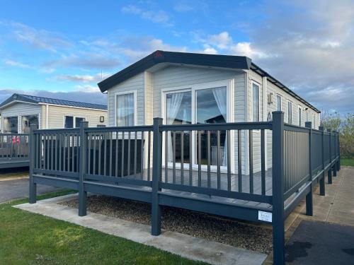 a tiny house with a fence around it at Firecrest Cove Thornwick Bay, Flamborough in Flamborough