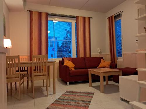 a living room with a couch and a table at RöhköStar 107 in Äkäslompolo