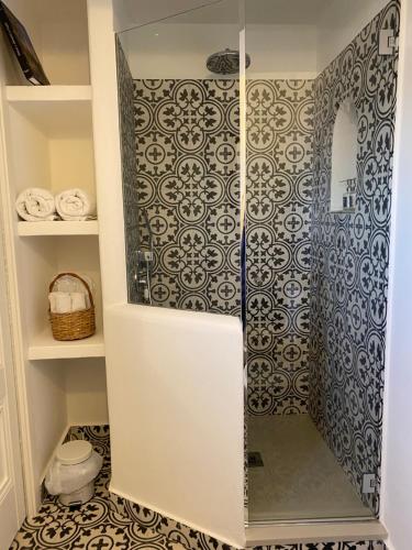 a walk in shower with a glass door in a bathroom at La Baia di Napoli in Capri