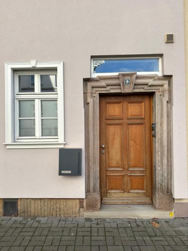 a building with a wooden door and a window at DOM LIVING - LuxusHaus in Fulda