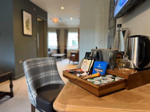 a wooden table with a box on top of it at The Forresters Arms Kilburn in Kilburn