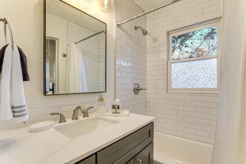 a white bathroom with a sink and a mirror at Walk Downtown and Canton Street Roswell Retreat! in Roswell