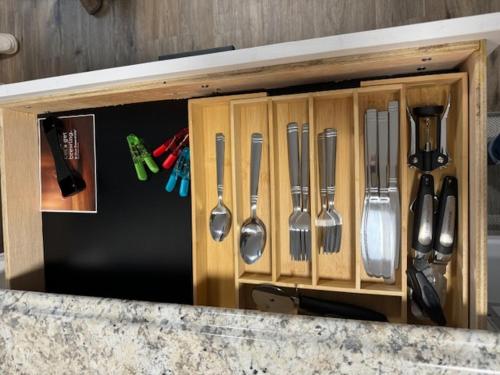 a wooden cabinet with utensils in it at Red Desert - Wyoming in Rock Springs