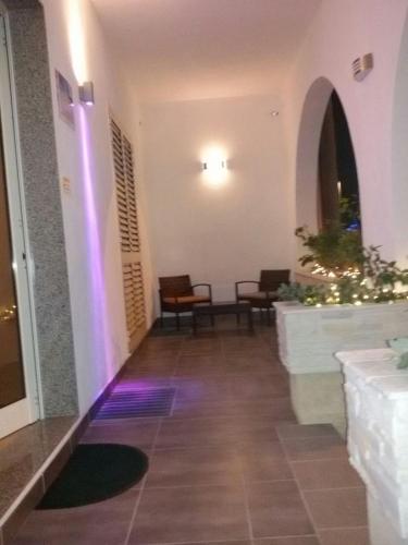 a hallway with purple lights in a building at Vianova Affittacamere in Giurdignano