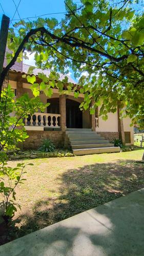 a house with stairs and a porch in front of it at Casa Dal Piaz in Garibaldi