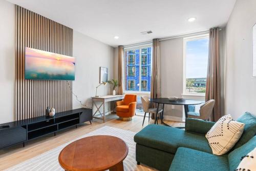 a living room with a couch and a table at Near Fishtown and Old City - King Bed - City Views in Philadelphia