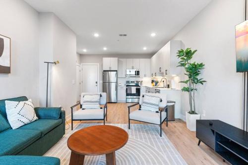 a living room with a couch and chairs and a table at Near Fishtown and Old City - King Bed - City Views in Philadelphia