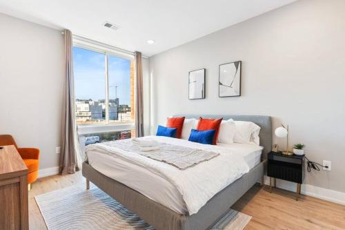 a bedroom with a large bed and a large window at Near Fishtown and Old City - King Bed - City Views in Philadelphia