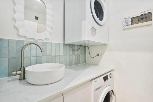 a white kitchen with a sink and a washing machine at REGL20/11 - East Perth Escape in Perth